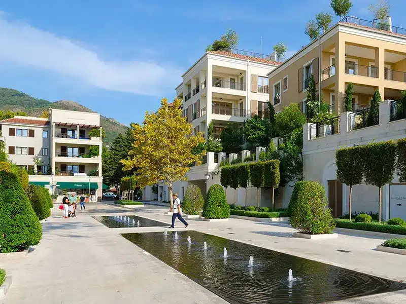 Selling Property A modern apartment complex with a water feature out front.